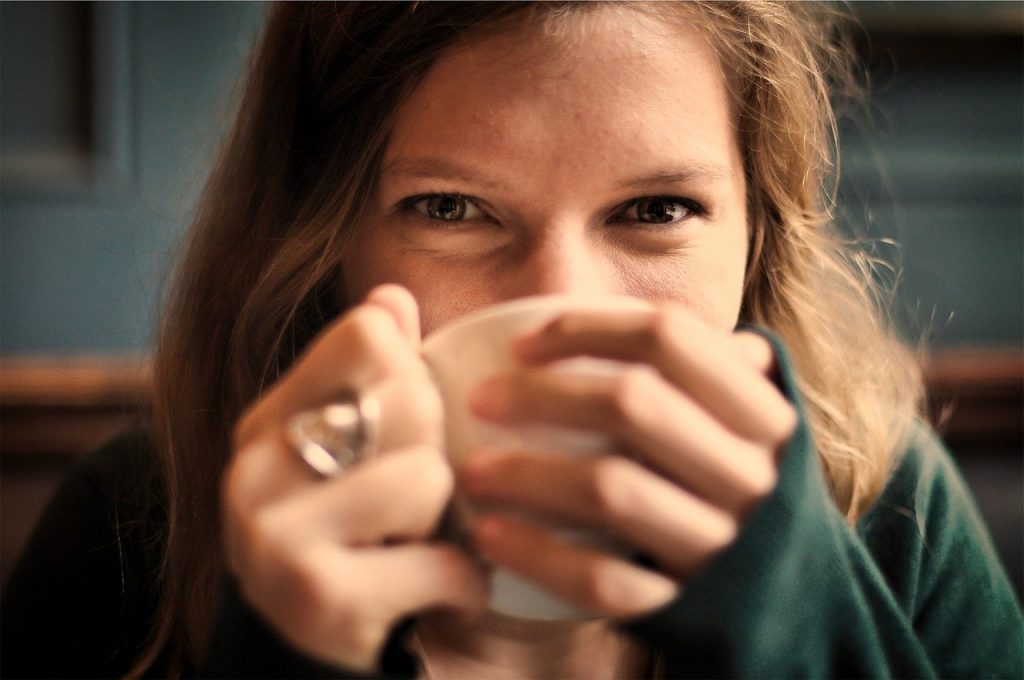 a woman holding her hands to her face