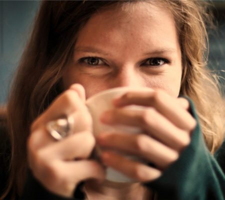 a woman holding her hands to her face