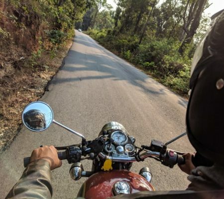 a man riding a motorcycle on a road