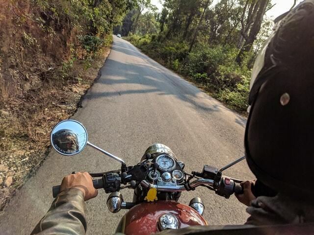 a man riding a motorcycle on a road