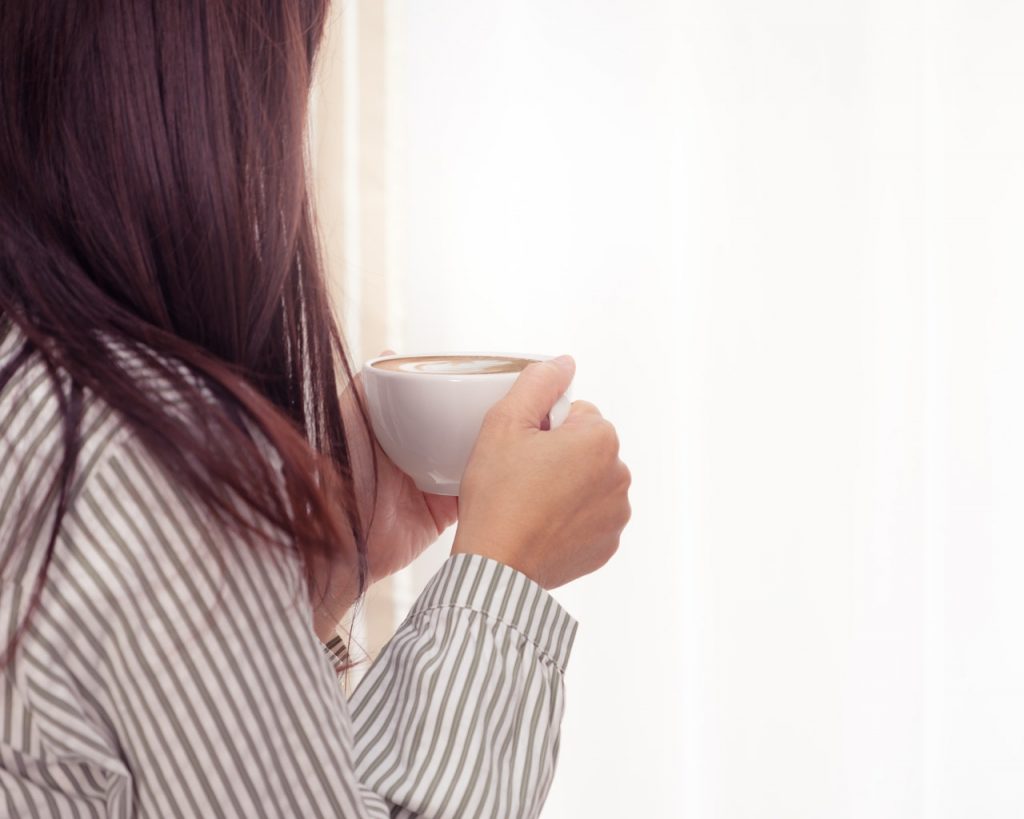 a woman holding a cup