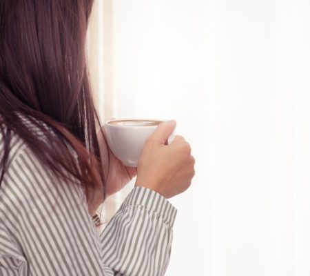 a woman holding a cup