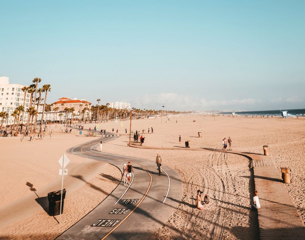 a beach with people and buildings