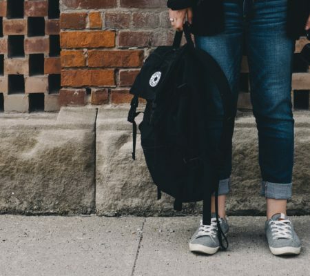 a man and woman walking down a sidewalk