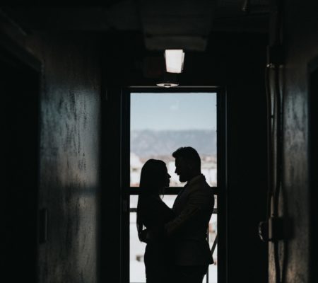 a man and woman looking out a window