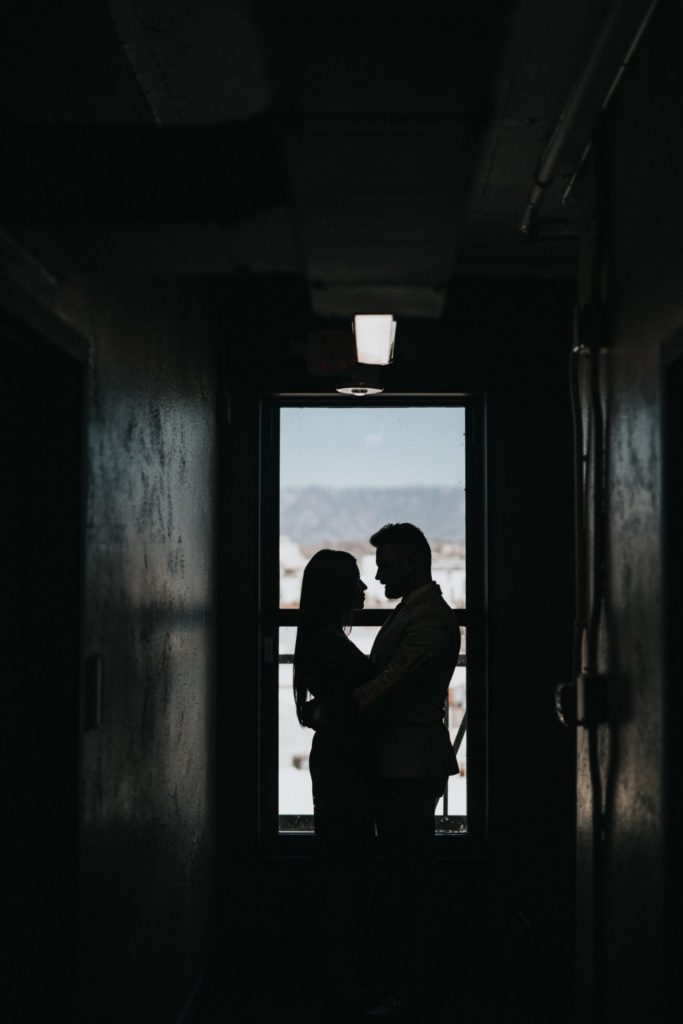 a man and woman looking out a window