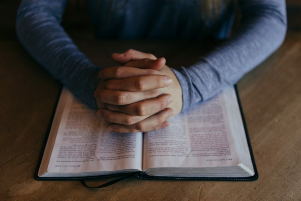 a person holding a pen and a book