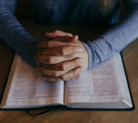 a person holding a pen and a book