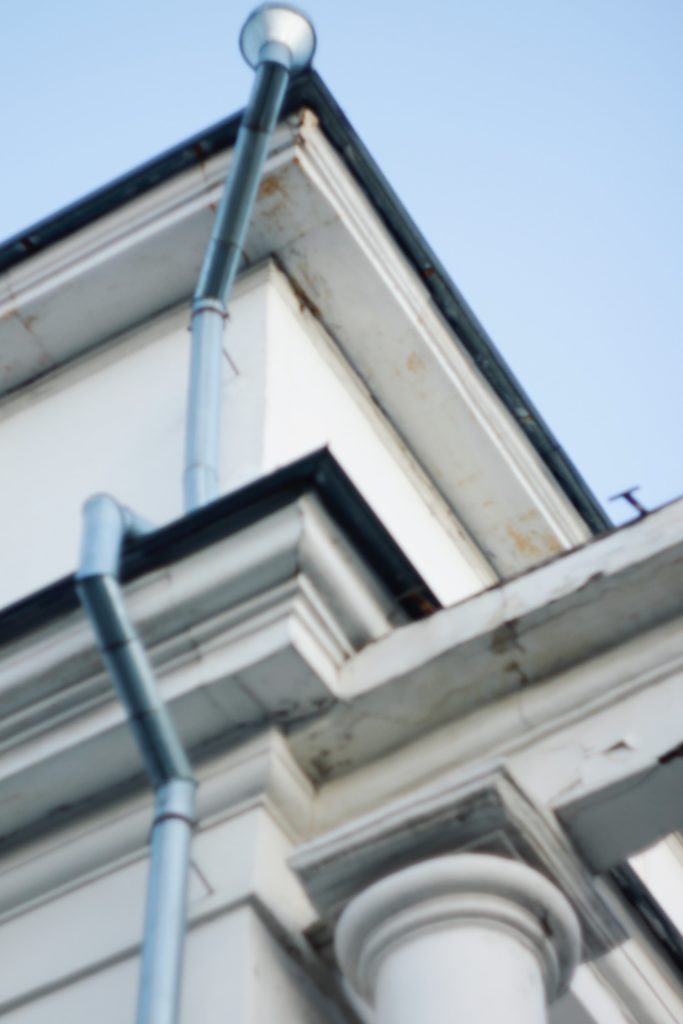 a white building with a metal railing