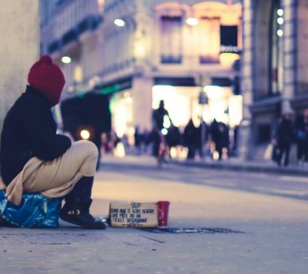 a man sitting on the sidewalk