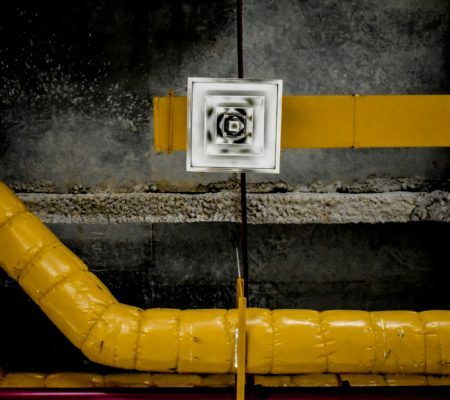 a yellow pipe with a white label