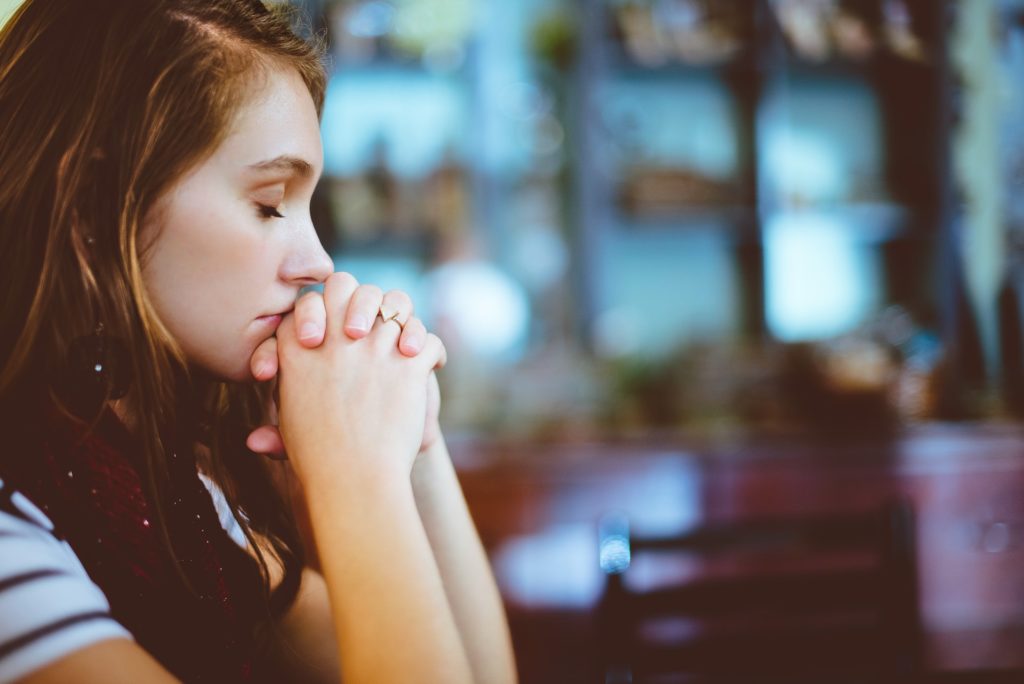 a woman with her hand on her mouth