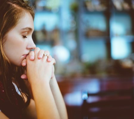 a woman with her hand on her mouth