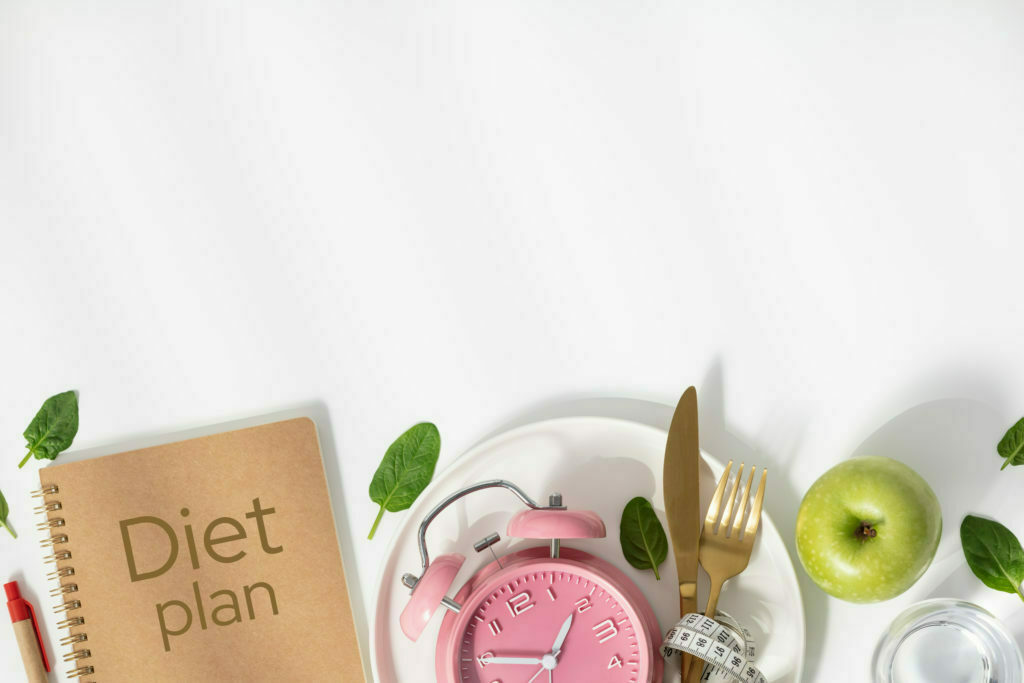 a clock and fork on a plate