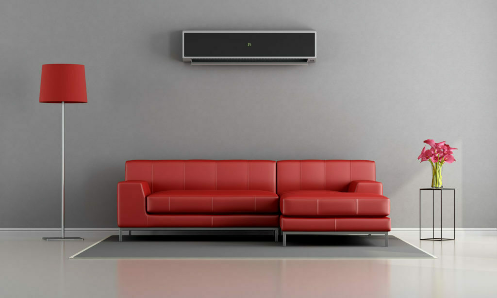 a red couch with a rectangular control