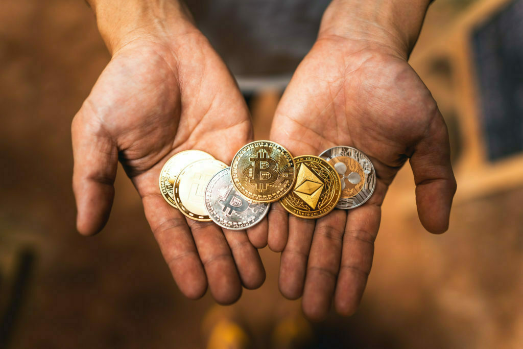 a group of hands holding coins