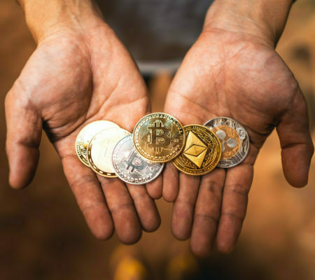 a group of hands holding coins