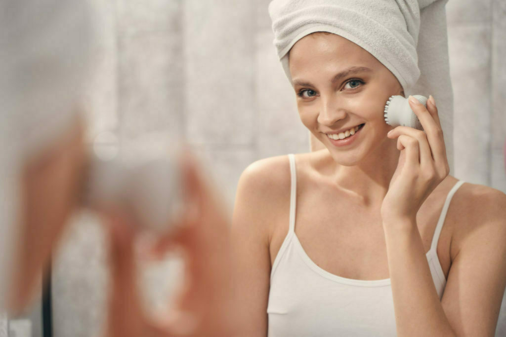 a woman smiling while holding a phone