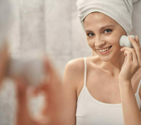 a woman smiling while holding a phone