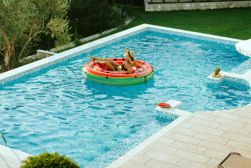 a man and woman in a go-kart in a pool