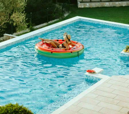 a man and woman in a go-kart in a pool